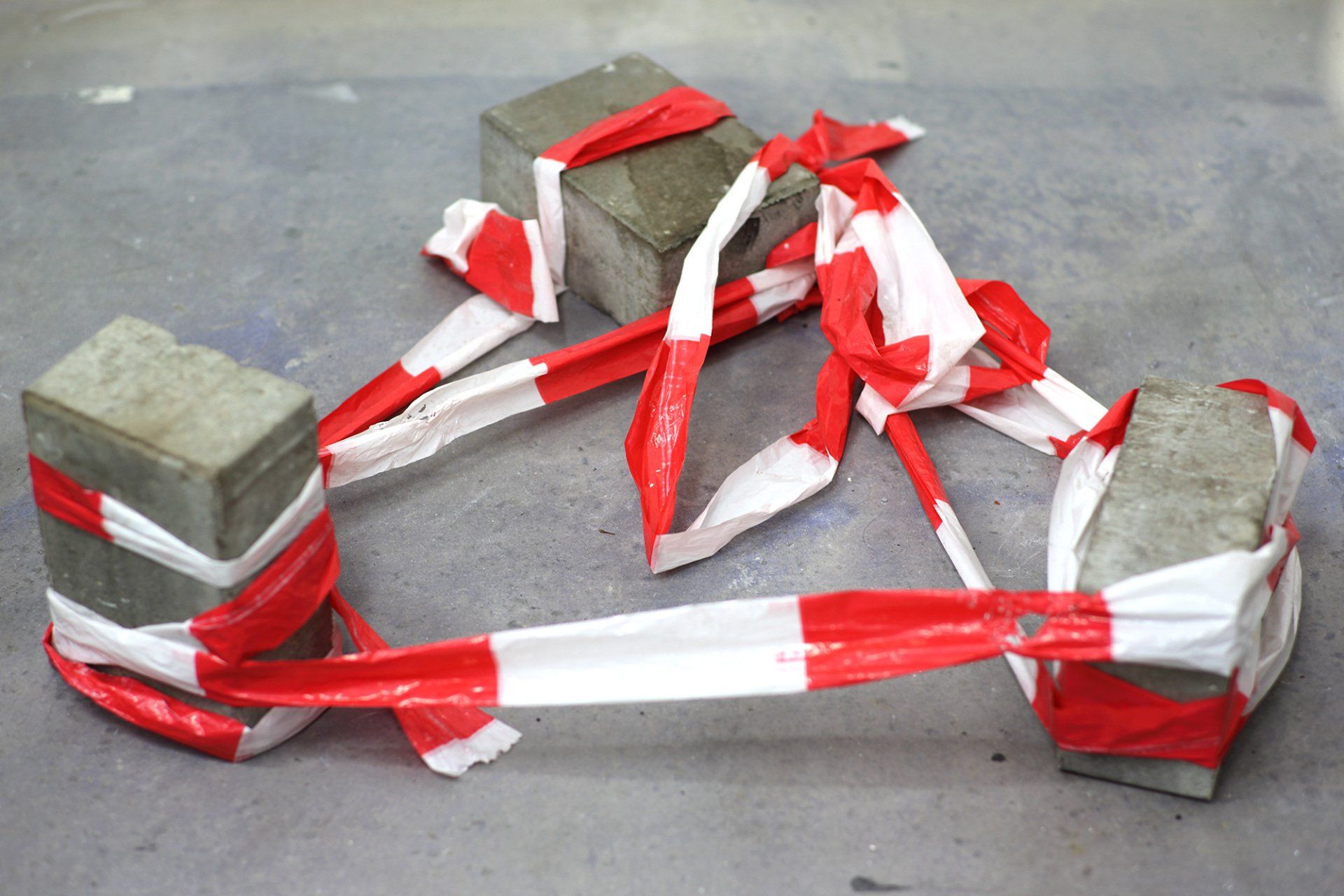 „Barrier Tape Art Sculpture No. 3“ by inventor of Barrier Tape Art, Sebastian Bieniek (B1EN1EK), 2020. Three stones and Barrier Tape. 90 cm. x 80 cm. x 24 cm. „Barrier Tape Art Sculpture No. 3“ by inventor of Barrier Tape Art, Sebastian Bieniek (B1EN1EK), 2020. Three stones and Barrier Tape. 90 cm. x 80 cm. x 24 cm.