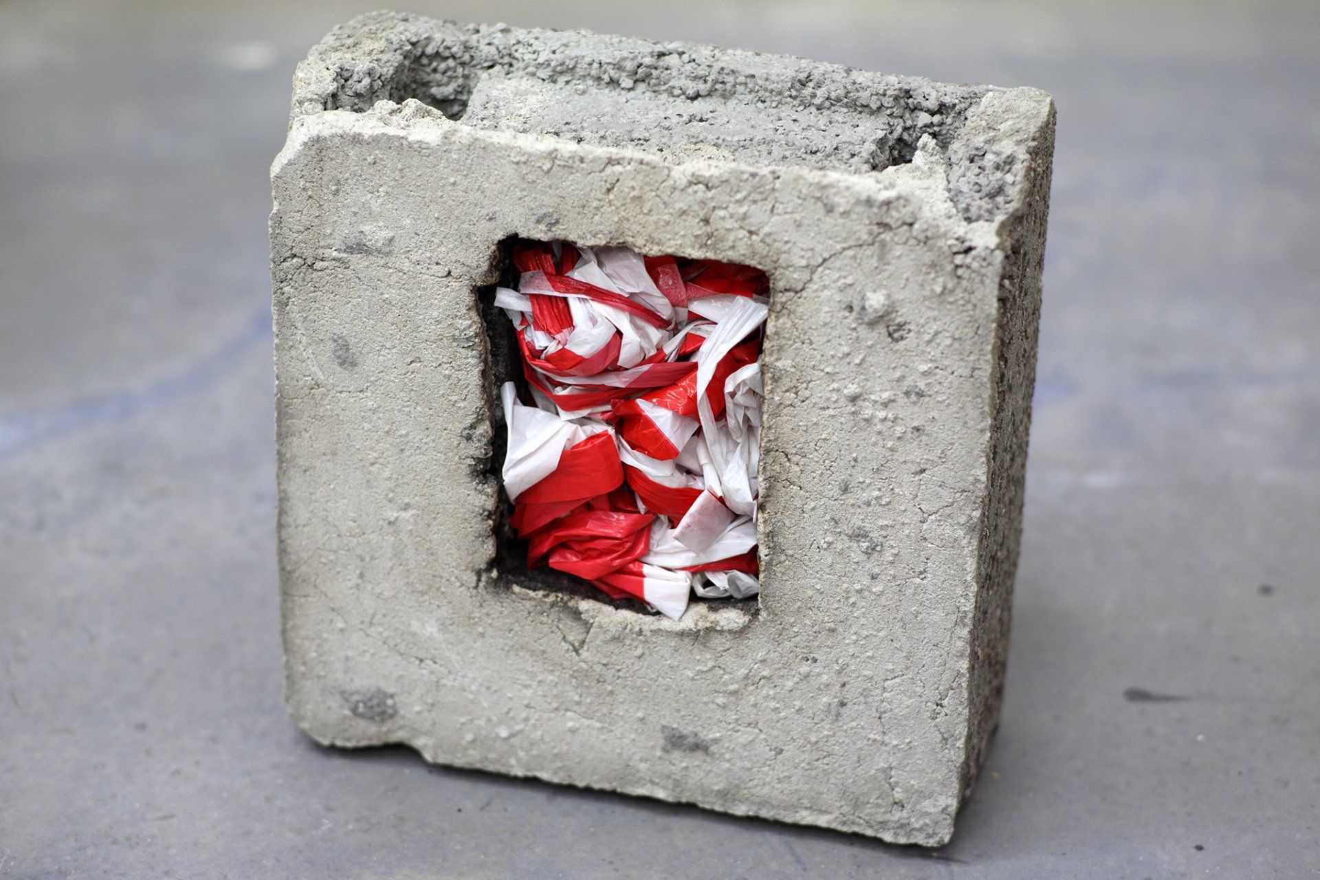 „Barrier Tape Art Sculpture No. 4“ by inventor of Barrier Tape Art, Sebastian Bieniek (B1EN1EK), 2020. Barrier Tape in concrete. 38 cm. x 15 cm. x 39 cm. „Barrier Tape Art Sculpture No. 4“ by inventor of Barrier Tape Art, Sebastian Bieniek (B1EN1EK), 2020. Barrier Tape in concrete. 38 cm. x 15 cm. x 39 cm.