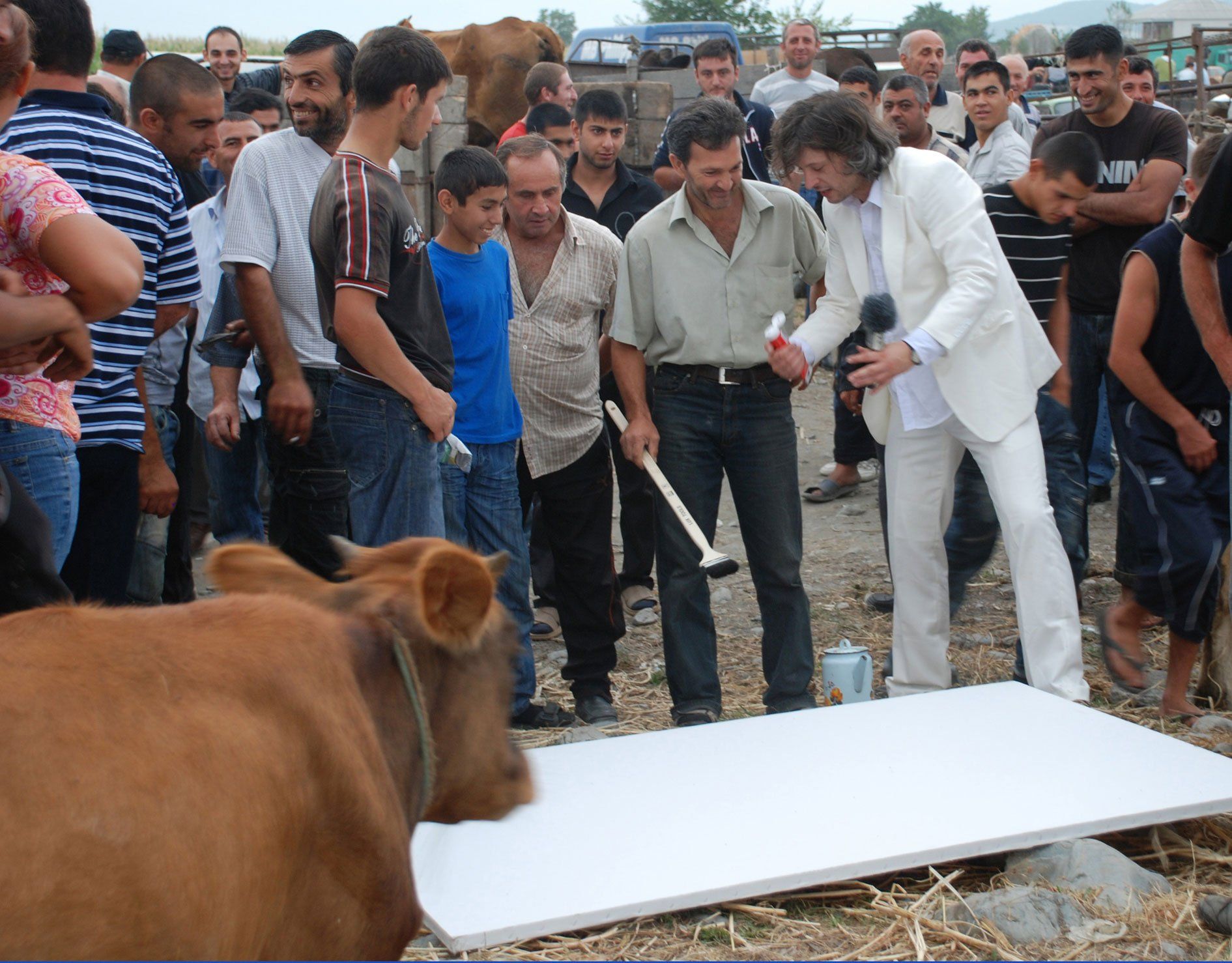 Pona, Georiga, 2011. Performance by Sebastian Bieniek on a Cattle Market. The people who make up the cattle market were encouraged to capture the cattle market on a painting. Pona, Georiga, 2011. Performance by Sebastian Bieniek on a Cattle Market. The people who make up the cattle market were encouraged to capture the cattle market on a painting.