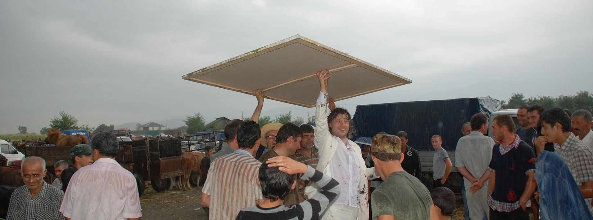 Pona, Georiga, 2011. Performance by Sebastian Bieniek on a Cattle Market. The people who make up the cattle market were encouraged to capture the cattle market on a painting. Pona, Georiga, 2011. Performance by Sebastian Bieniek on a Cattle Market. The people who make up the cattle market were encouraged to capture the cattle market on a painting.