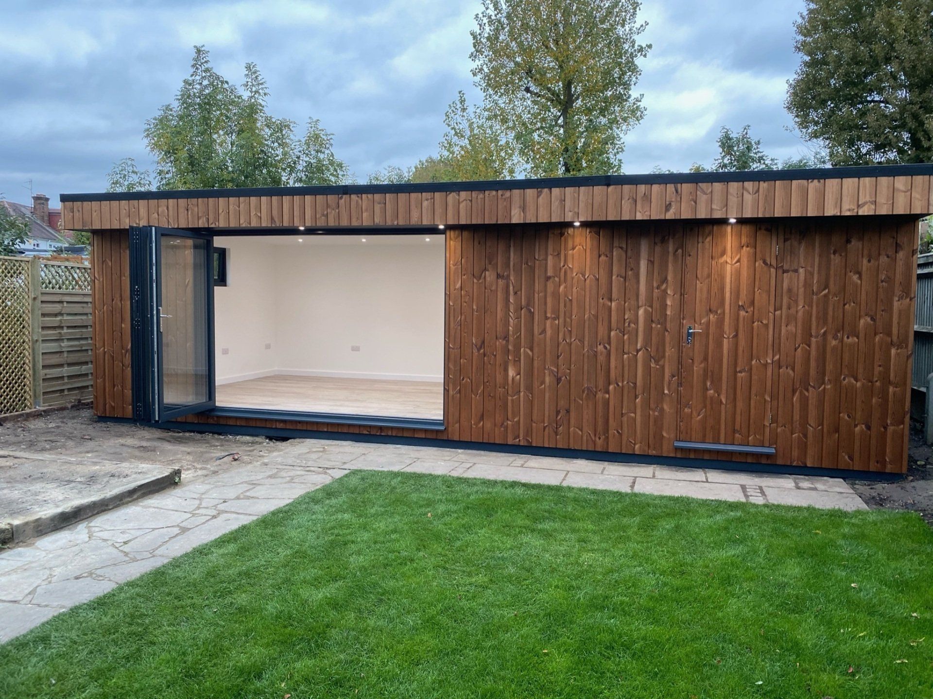 Modern granny annexe with open-plan living and large windows built by TRJ Construction Ltd