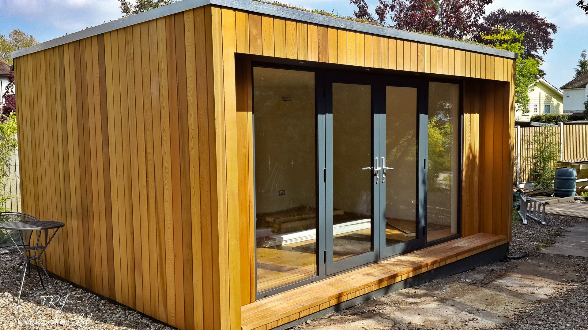 Red cedar garden room constructed with SIP panels, showcasing a modern and sustainable design