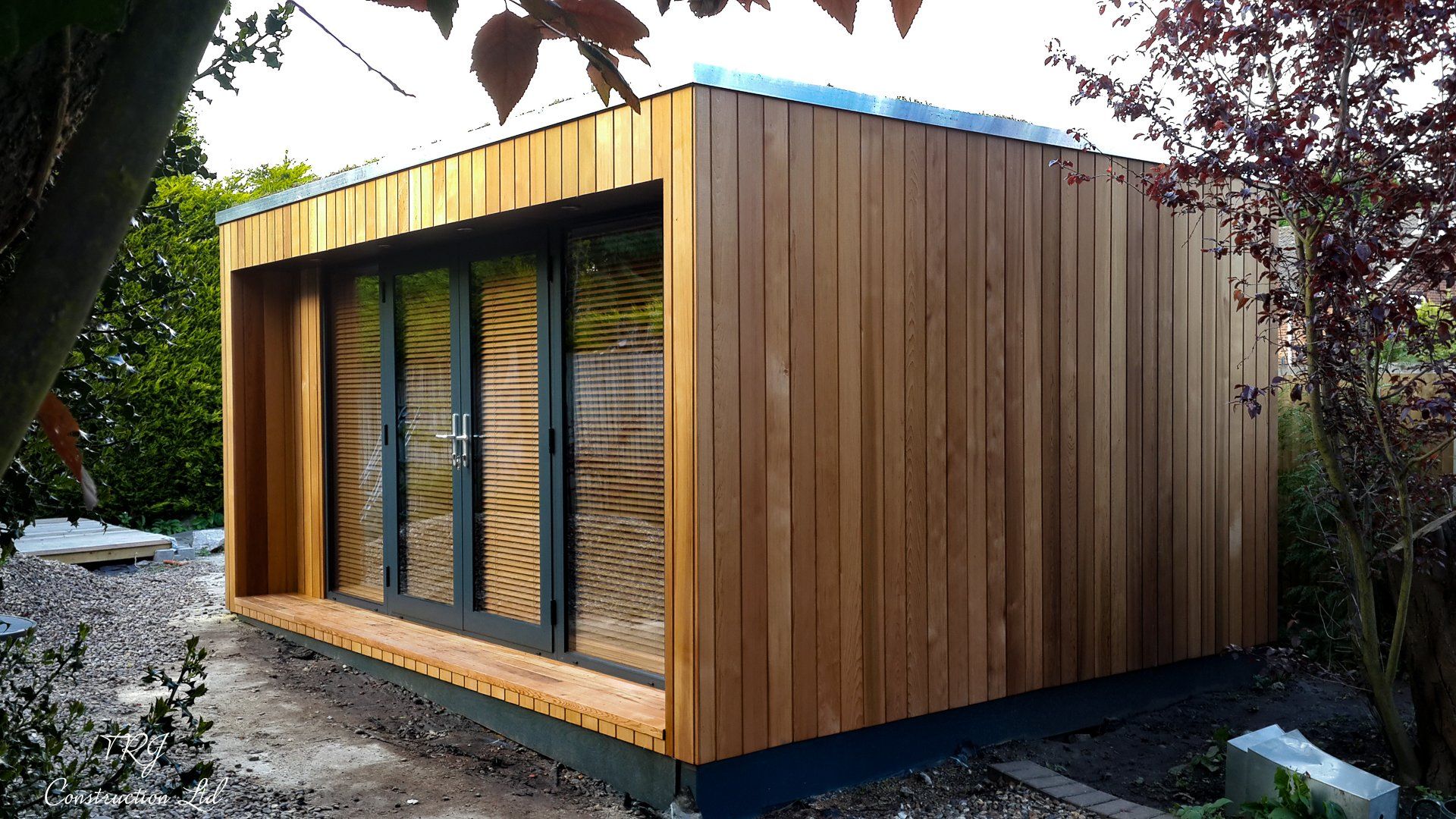 Red cedar garden room constructed with SIP panels, showcasing a modern and sustainable design