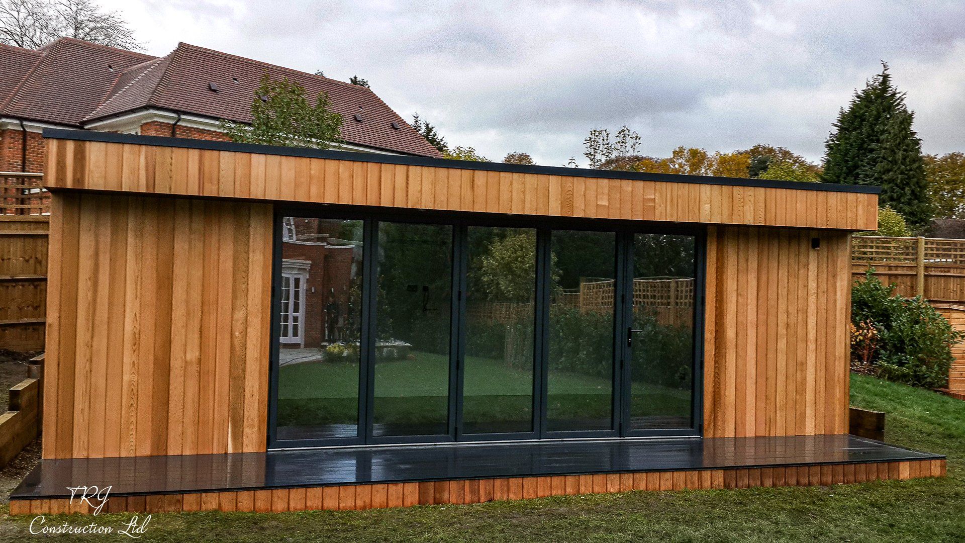 Red cedar garden room constructed with SIP panels, showcasing a modern and sustainable design