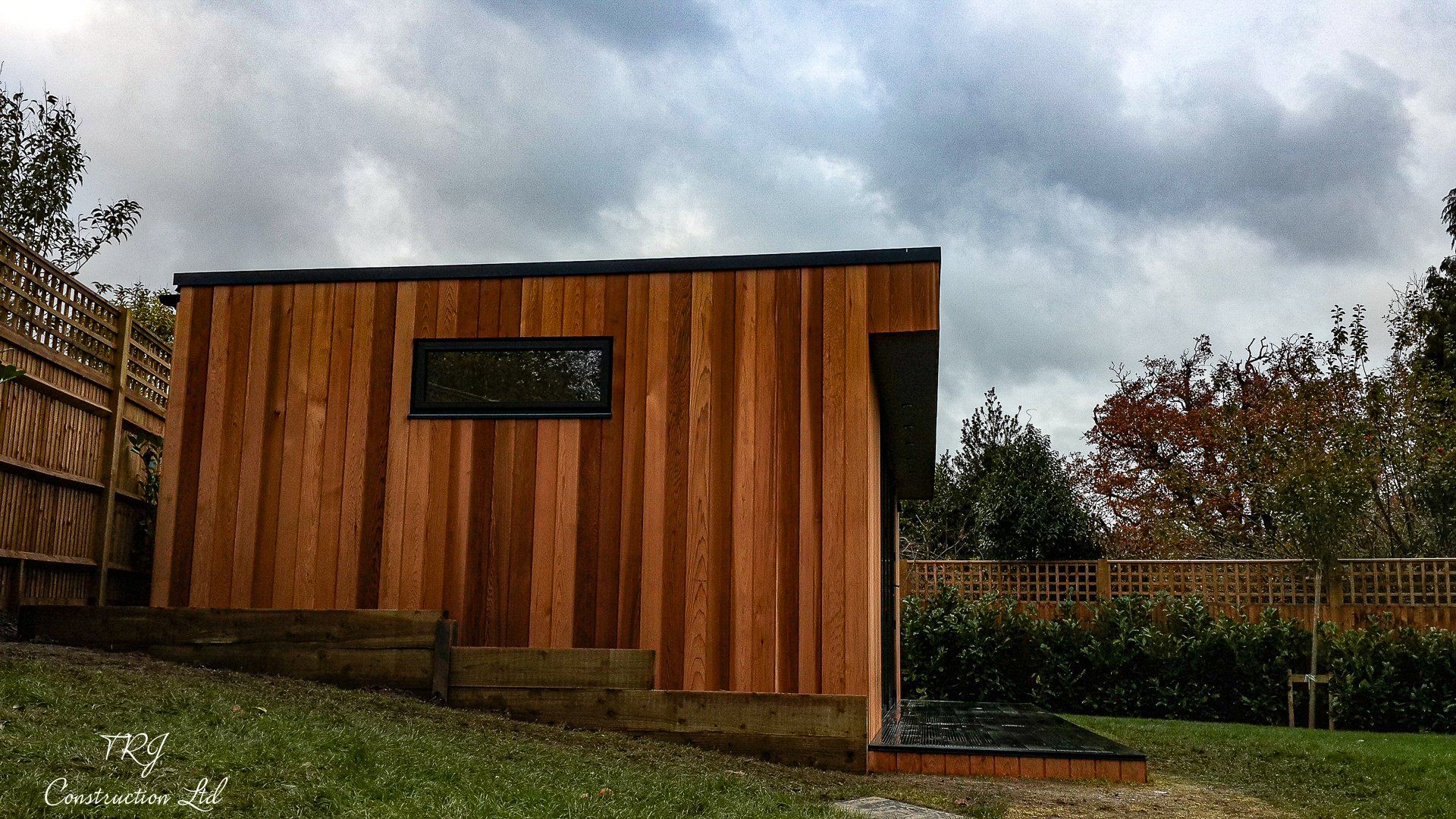 Red cedar garden room constructed with SIP panels, showcasing a modern and sustainable design