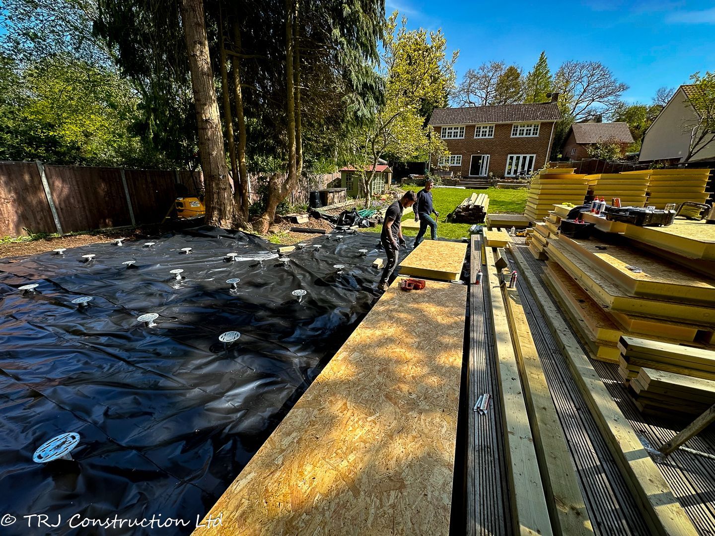 A house foundation being fitted with durable SIP panels.