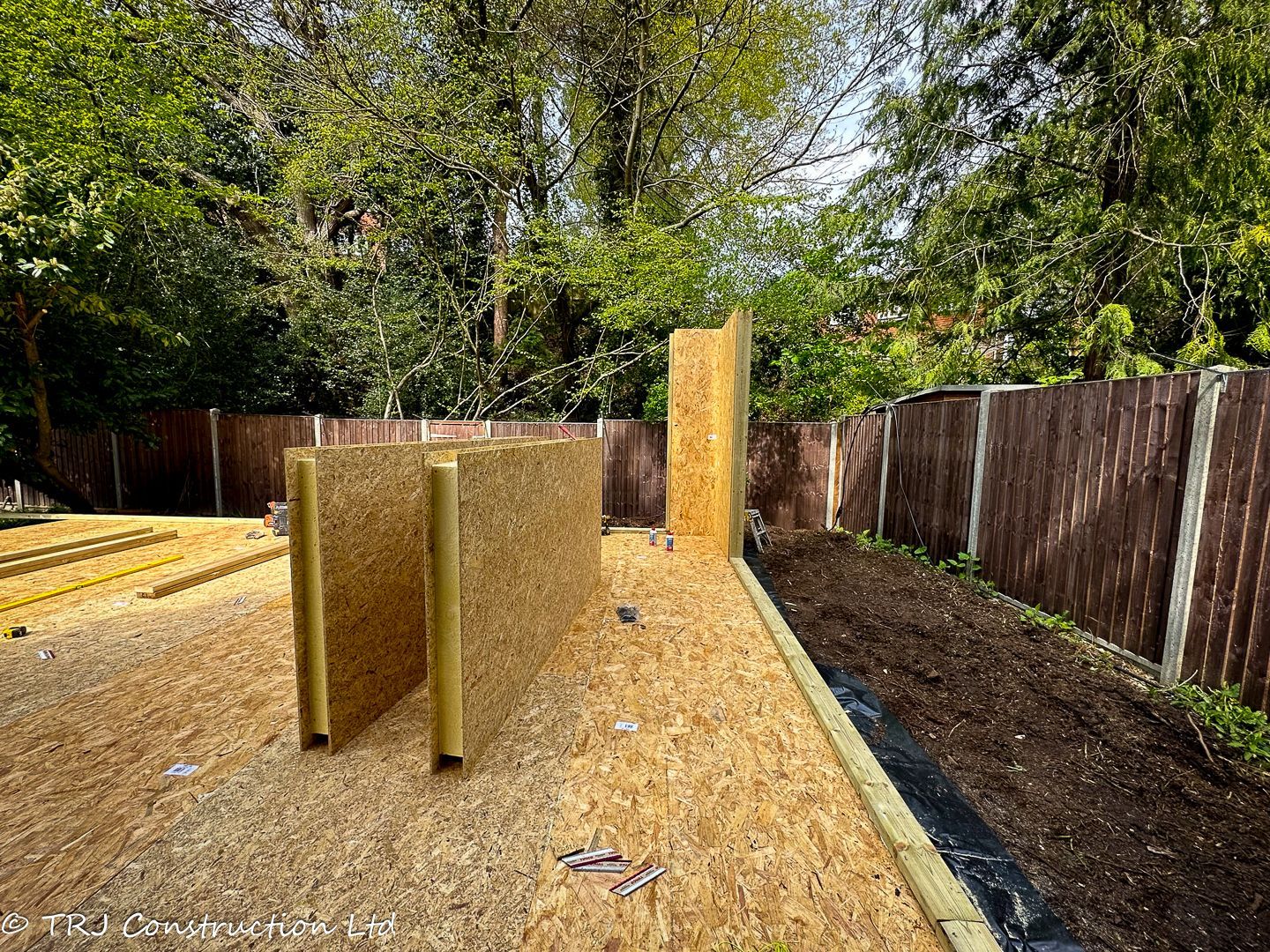 Structural Insulated Panels (SIPs) stacked for a construction project.