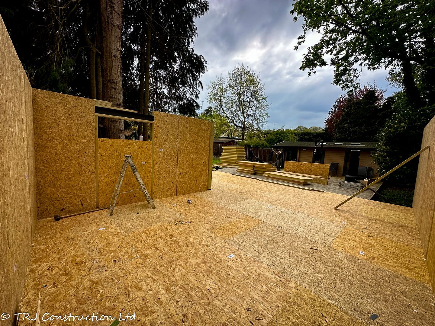 Builders assembling SIP panels for a rapid home construction.