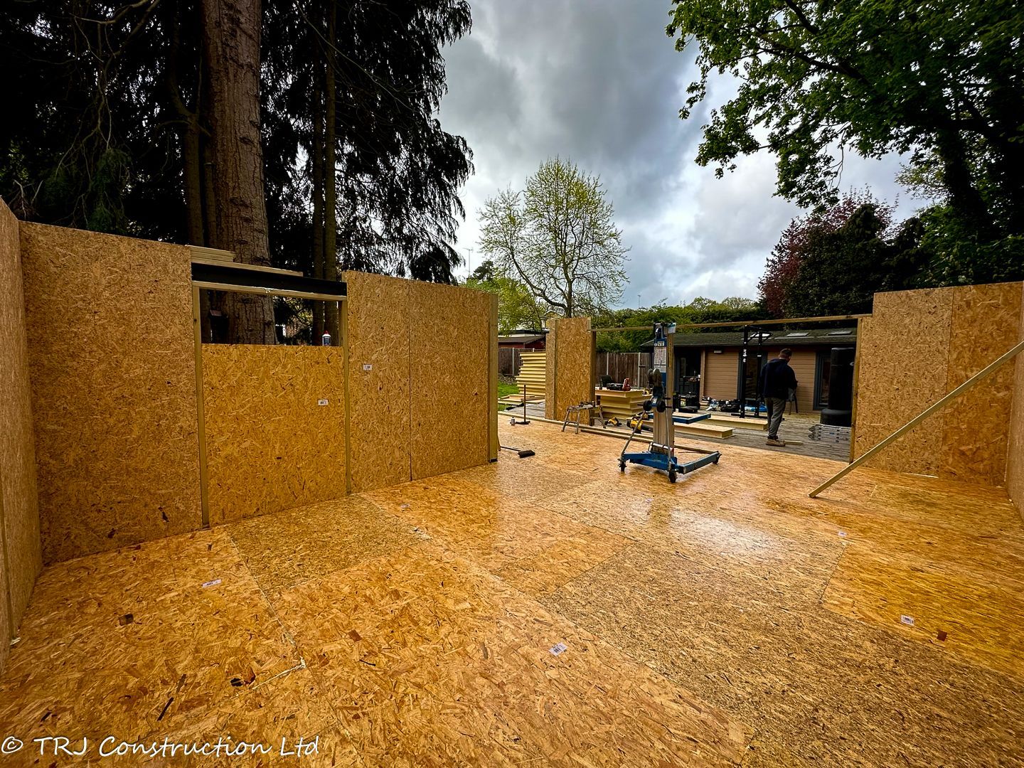 A house foundation being fitted with durable SIP panels.