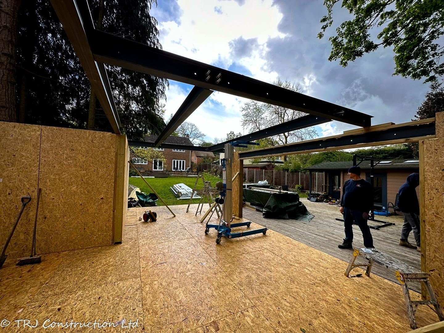 Builders assembling SIP panels for a rapid home construction.
