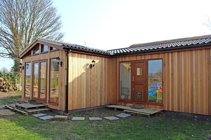 Modern granny annexe with open-plan living and large windows built by TRJ Construction Ltd