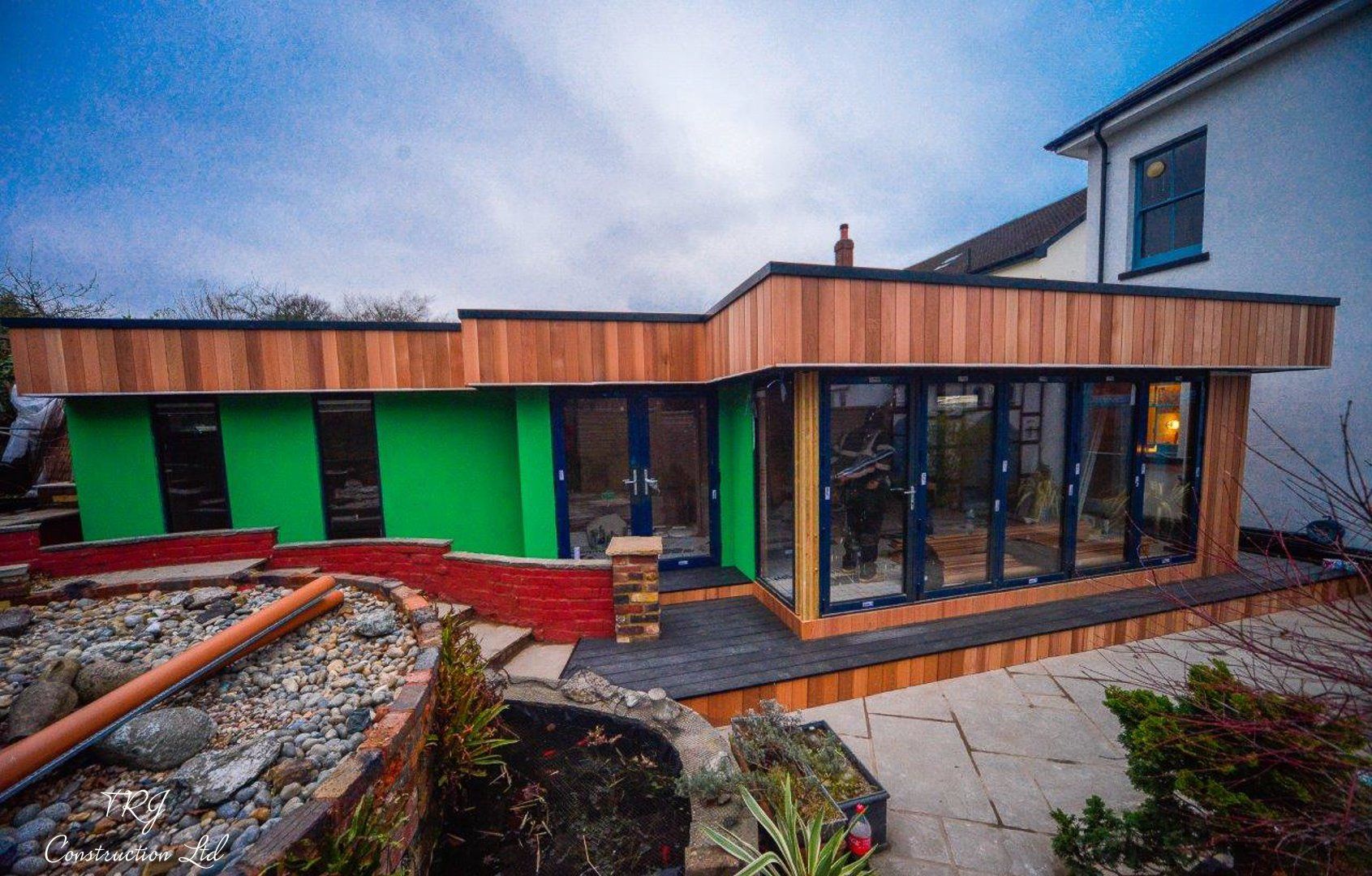 Red cedar garden room constructed with SIP panels, showcasing a modern and sustainable design