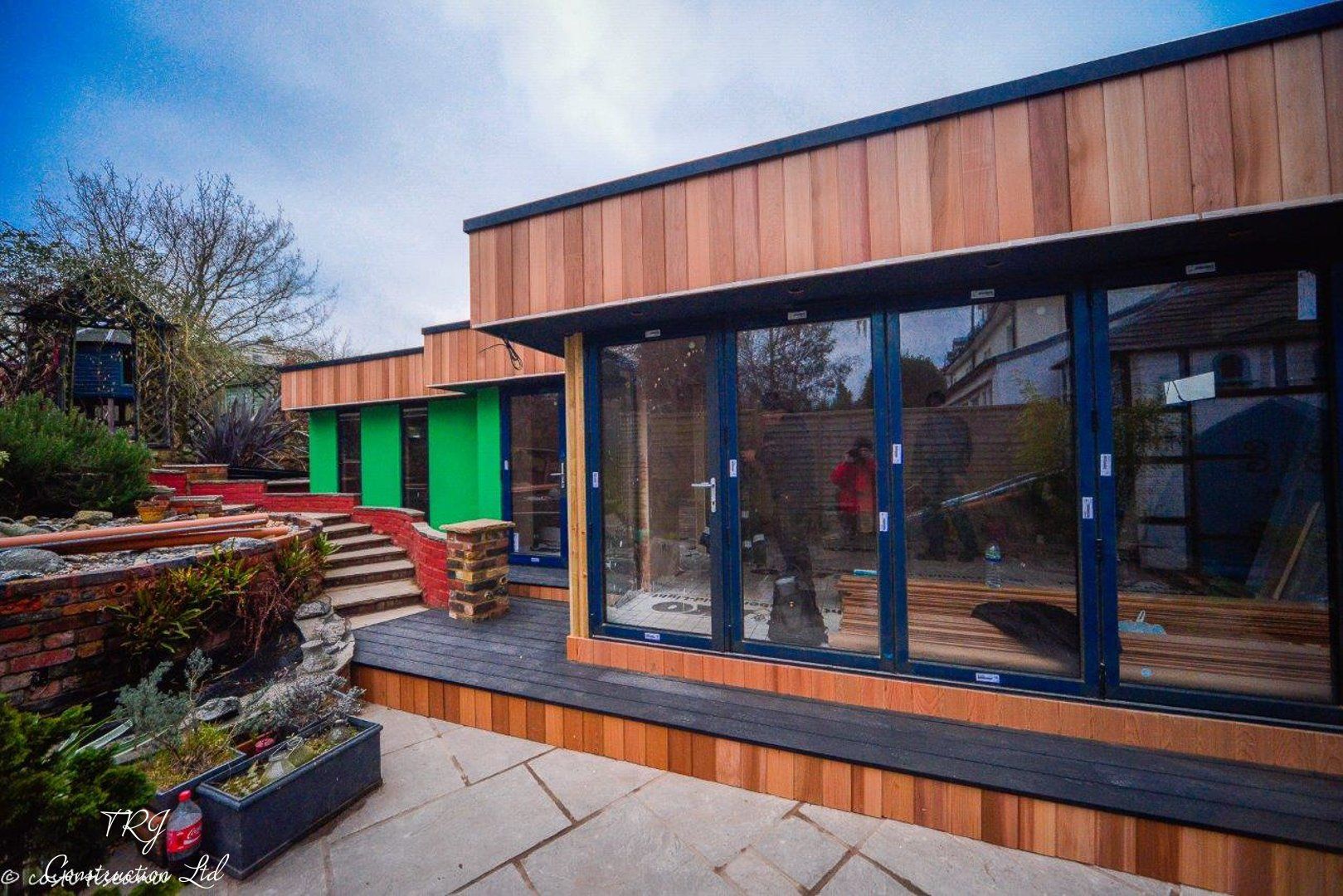 Red cedar garden room constructed with SIP panels, showcasing a modern and sustainable design