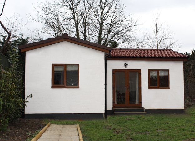 Modern granny annexe with open-plan living and large windows built by TRJ Construction Ltd