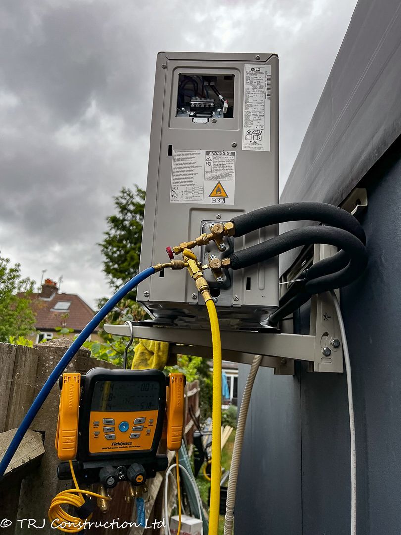 An air conditioning technician testing a newly installed system.