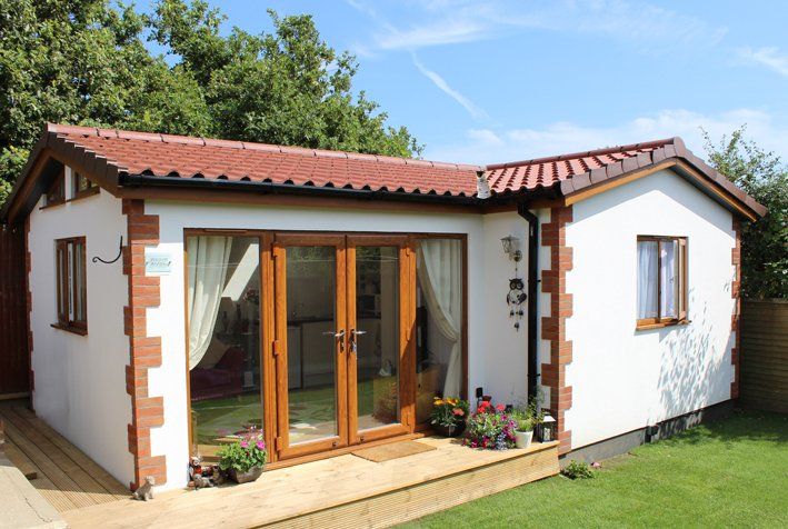 Modern granny annexe with open-plan living and large windows built by TRJ Construction Ltd