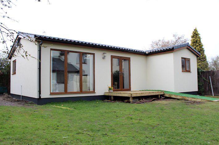 Modern granny annexe with open-plan living and large windows built by TRJ Construction Ltd