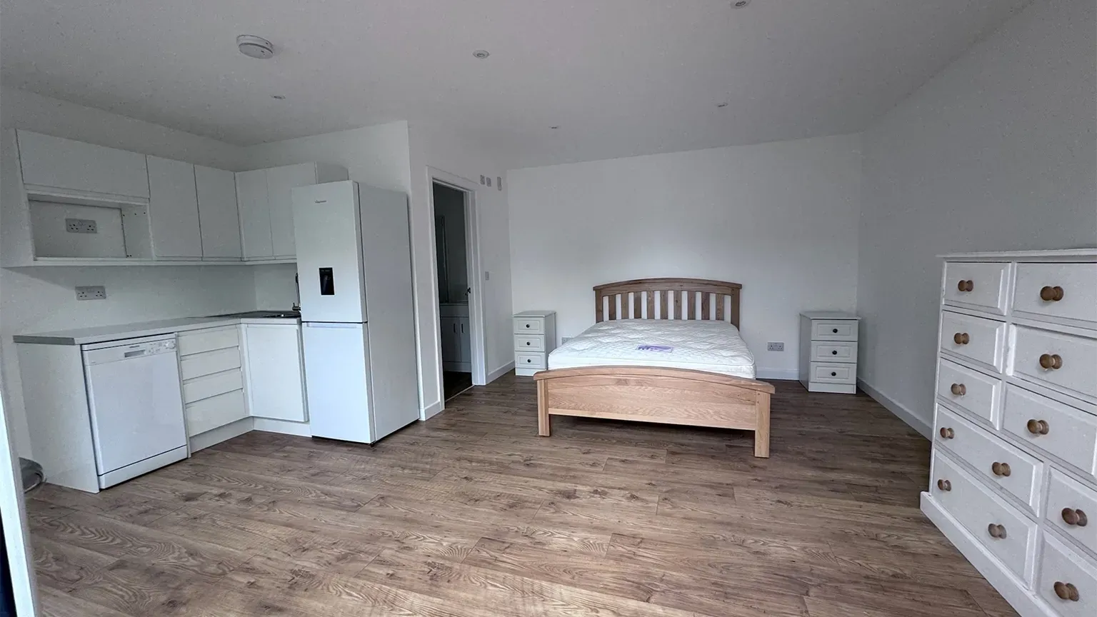 IP granny annexe in Mill Hill with white K render, deep foundations, planning permission, building control, and full interior fit-out by TRJ Construction.