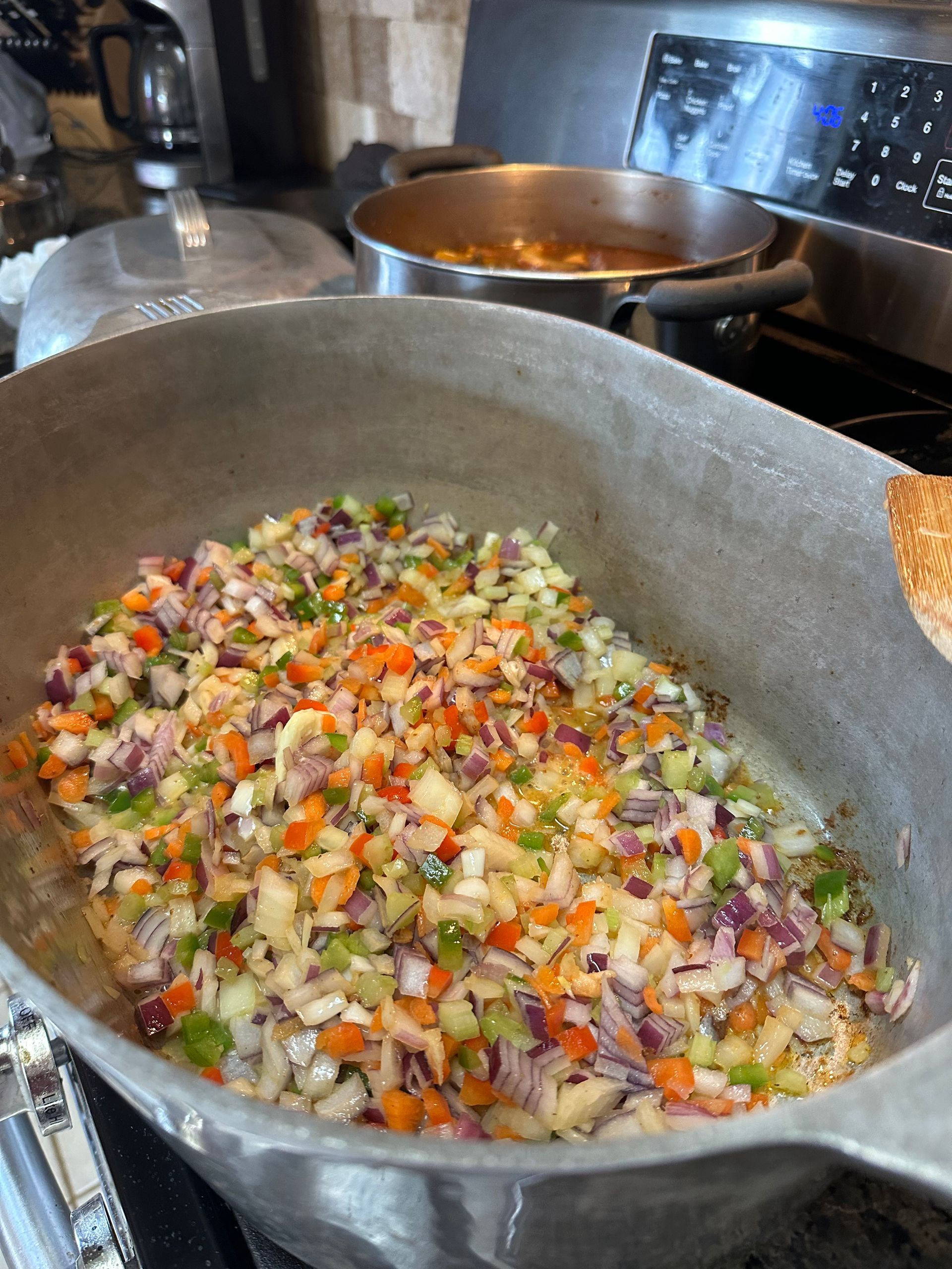 fresh seasonings being sauteed in a magnalite pot