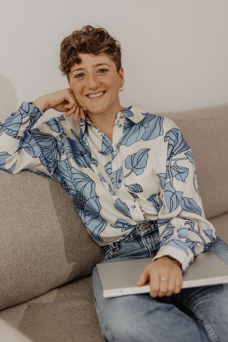 Online-Marketing für Berater und Coaches: Steffi Müsse sitzt mit dem Laptop auf dem Schoß auf einer Couch