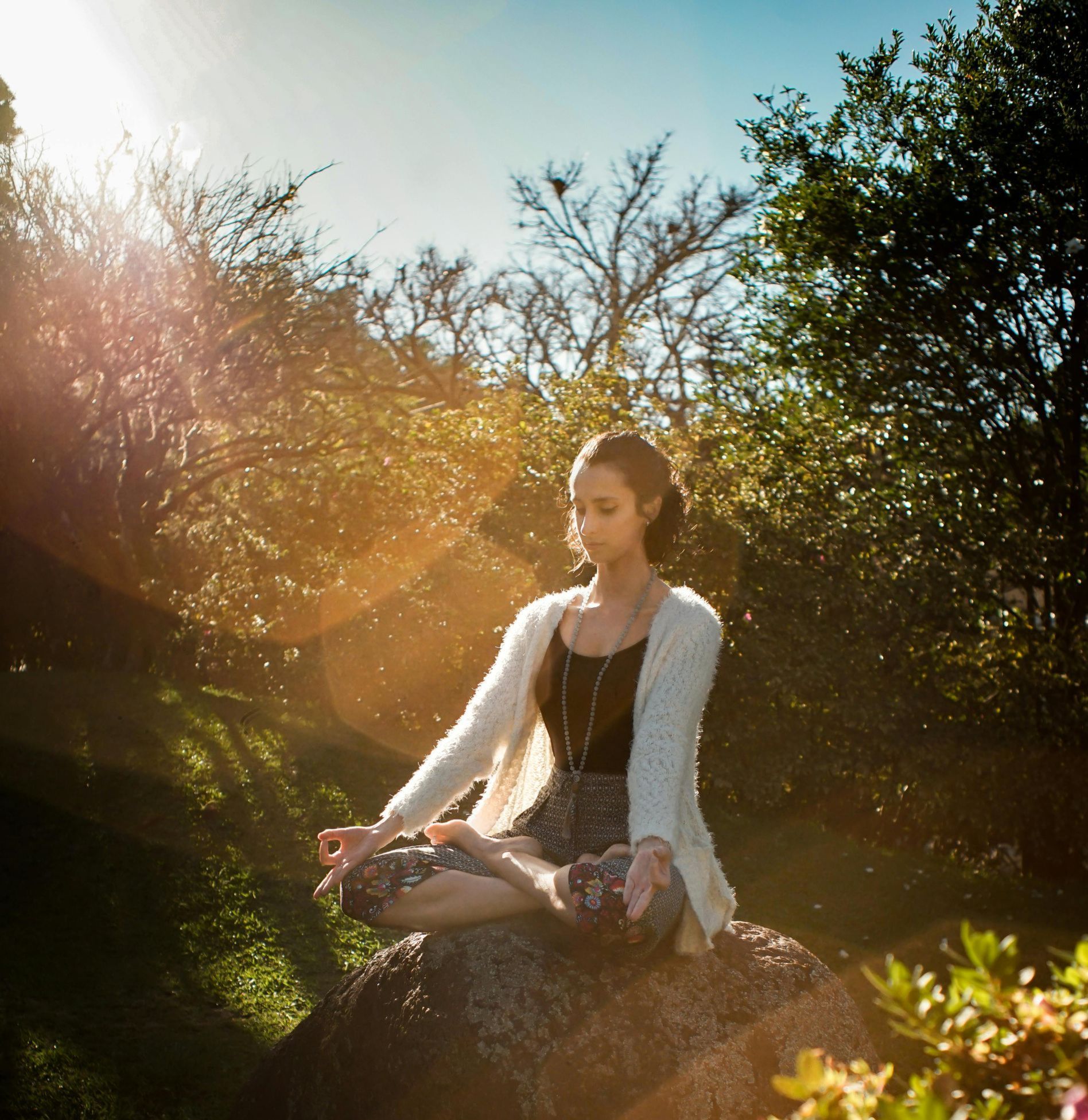 A woman meditating in a garden