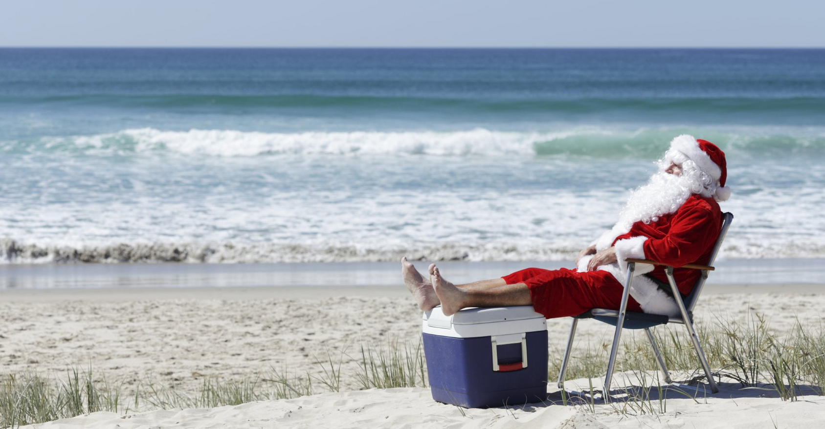 Santa with his feet up at the beach