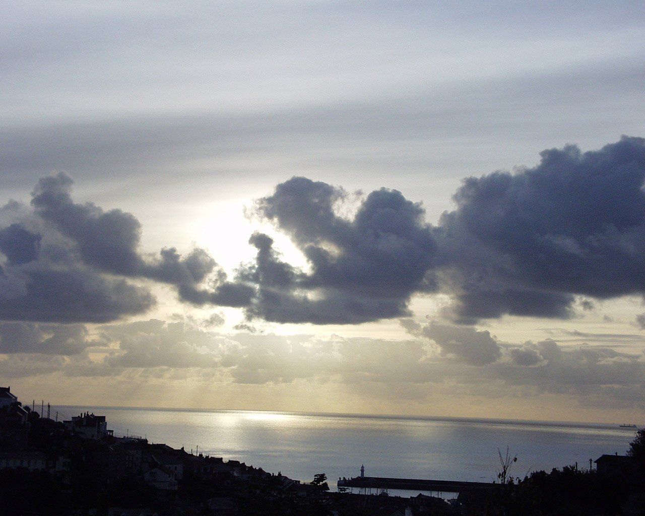 grey cloud sunrise over Mevagissey L A Kent Rogue Flamingo DI Treloar series