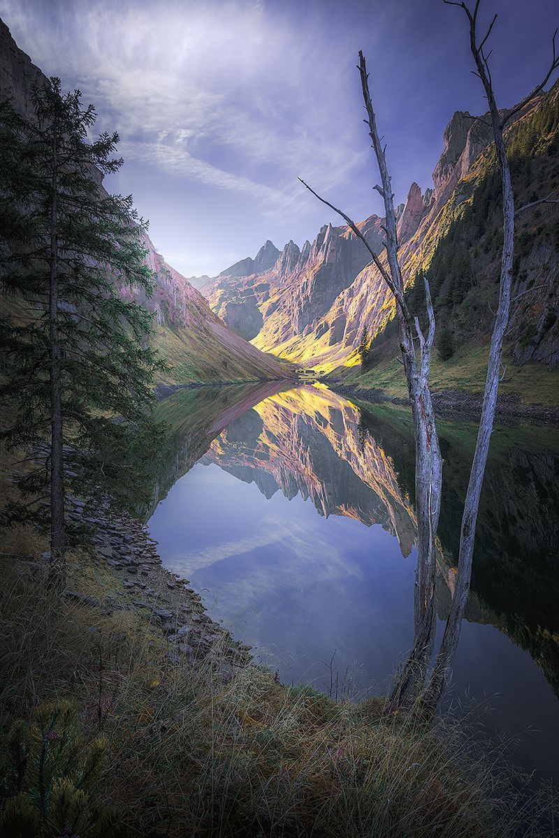 Landscape picture Hidden Wonder - The Faehlensee with reflection of the mountain scenery in the water.