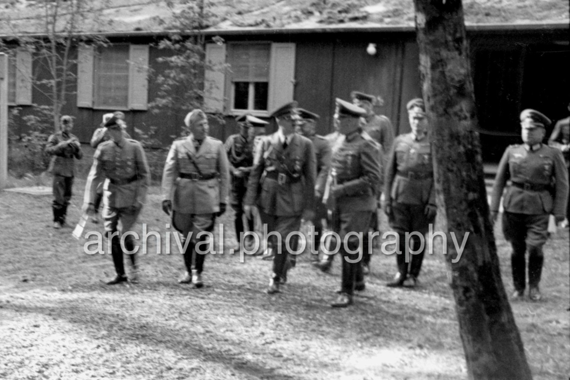 Hitler, Mussolini and SS German officers walking toward car - Nazi Adolf Hitler and the Italian 'Il Duce' Benito Mussolini on the train platform at the 'Wolfsschanze' Wolf's Lair headquarters at Rastenburg in East Prussia