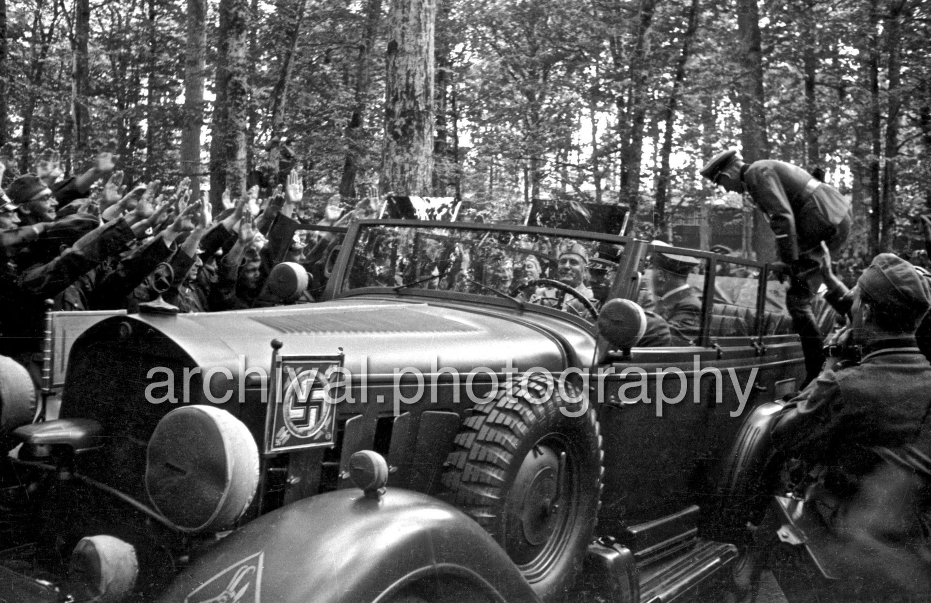 Nazi Hitler and Mussolini driving through crowd of SS - Nazi Adolf Hitler and the Italian 'Il Duce' Benito Mussolini on the train platform at the 'Wolfsschanze' Wolf's Lair headquarters at Rastenburg in East Prussia - Daimler Benz Aktiengesellschaft G4 touring wagon