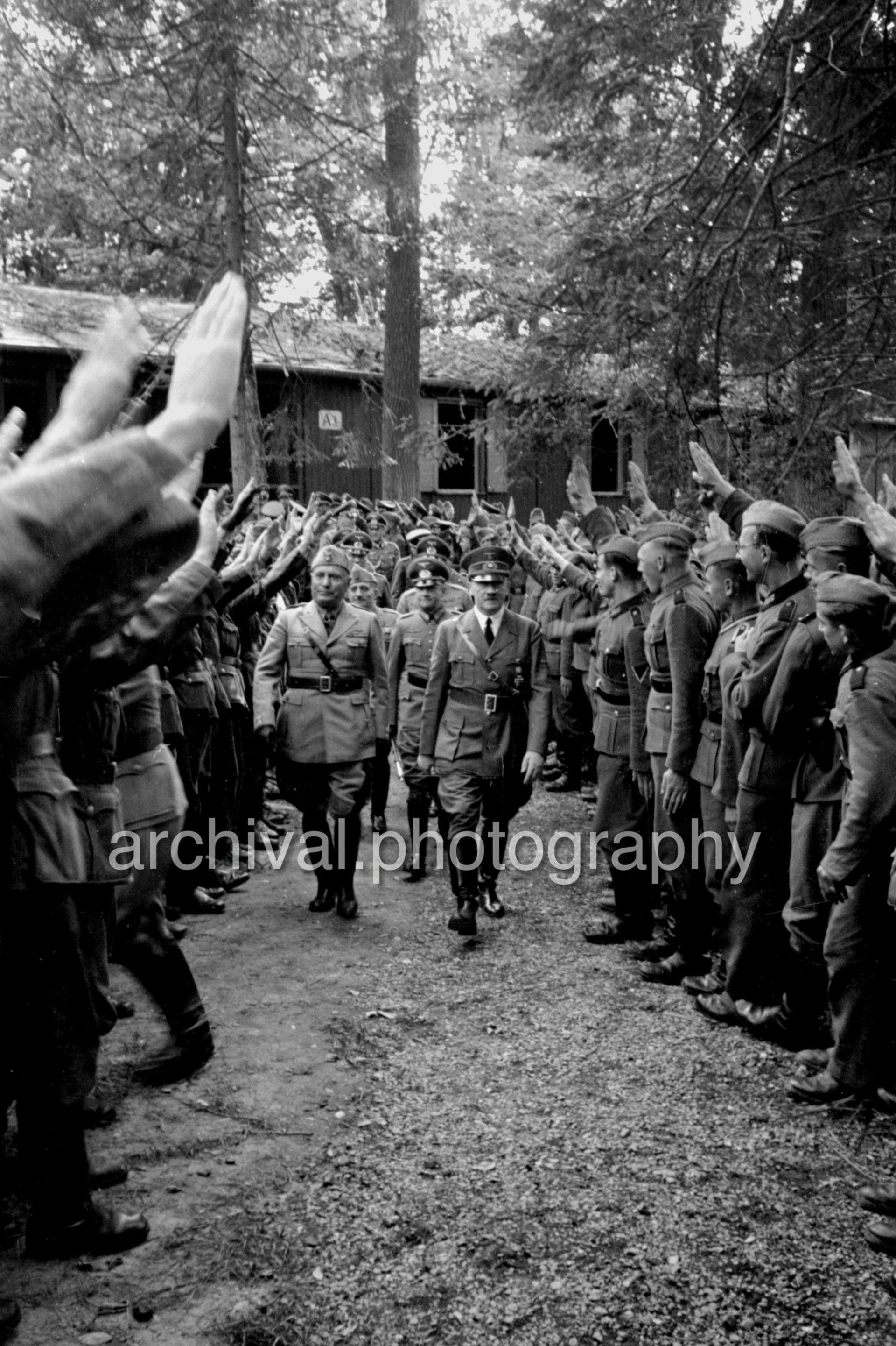 SS saluting Hitler and Mussolini as they walk through crowd - Nazi Adolf Hitler and the Italian 'Il Duce' Benito Mussolini on the train platform at the 'Wolfsschanze' Wolf's Lair headquarters at Rastenburg in East Prussia