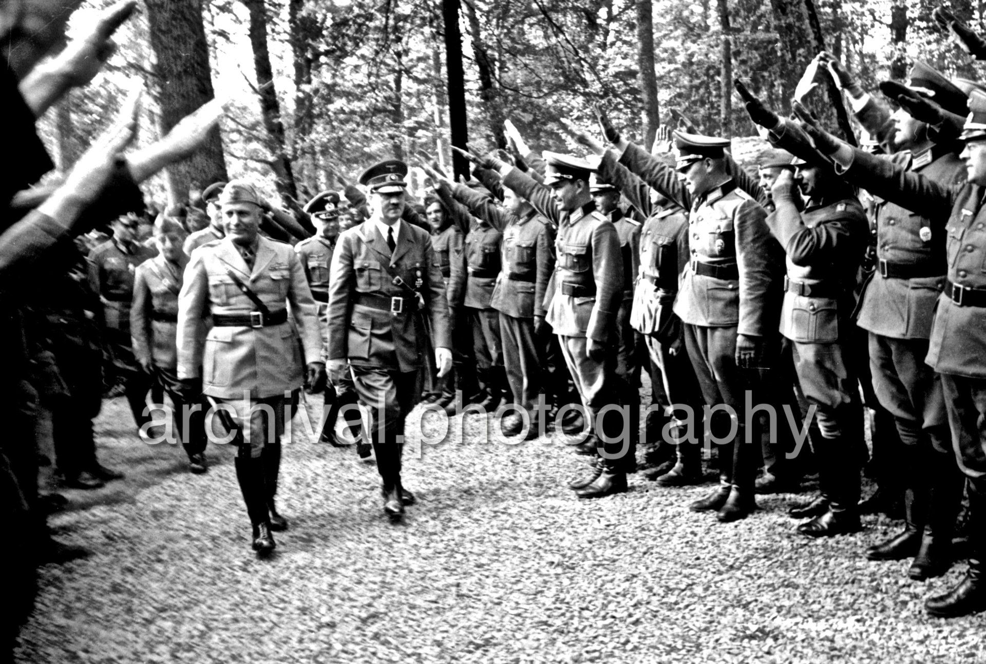 SS saluting Hitler and Mussolini as they walk through crowd - Nazi Adolf Hitler and the Italian 'Il Duce' Benito Mussolini on the train platform at the 'Wolfsschanze' Wolf's Lair headquarters at Rastenburg in East Prussia