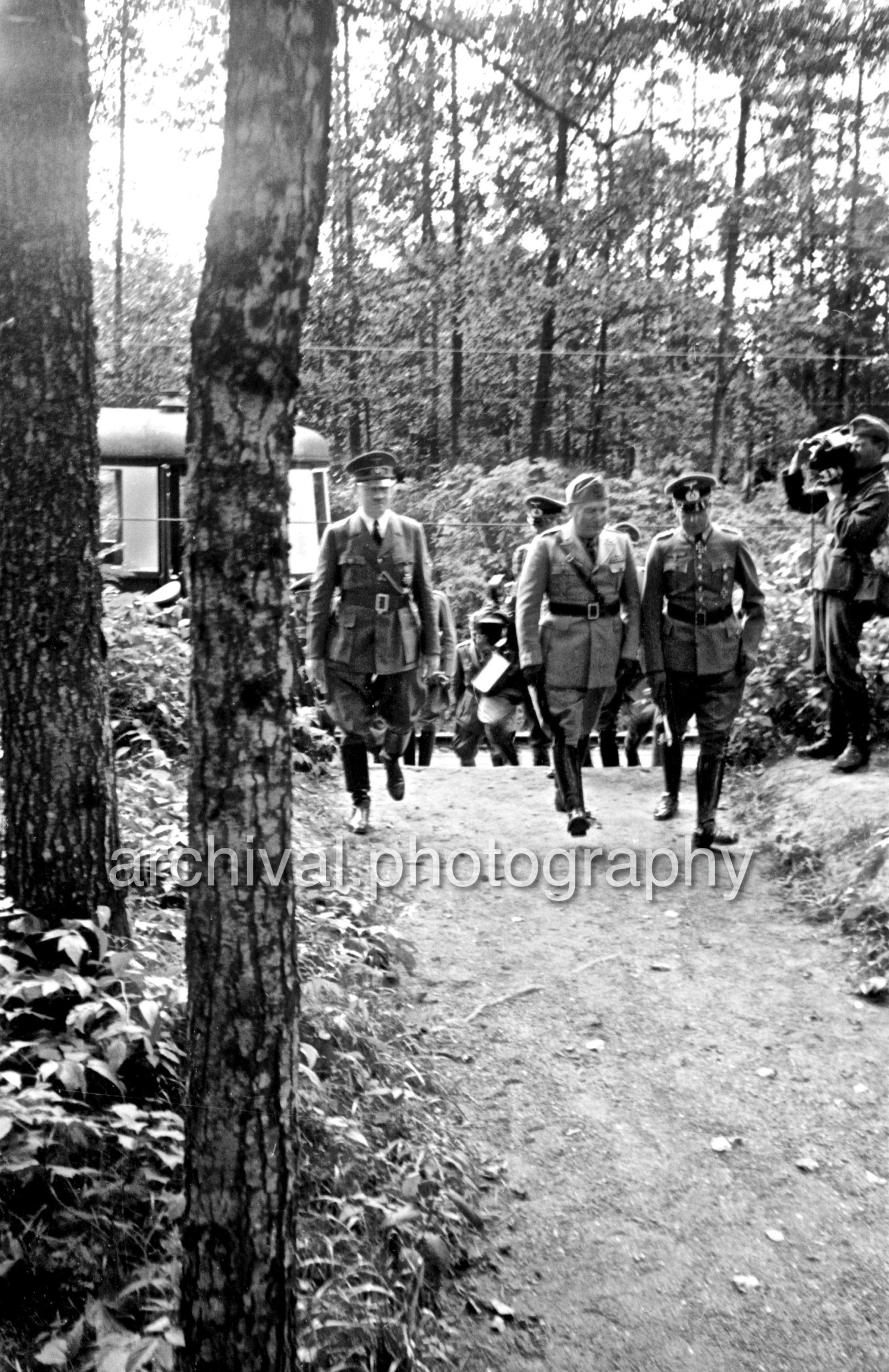 Hitler, Mussolini and German officers walking away from train - Nazi Adolf Hitler and the Italian 'Il Duce' Benito Mussolini on the train platform at the 'Wolfsschanze' Wolf's Lair headquarters at Rastenburg in East Prussia