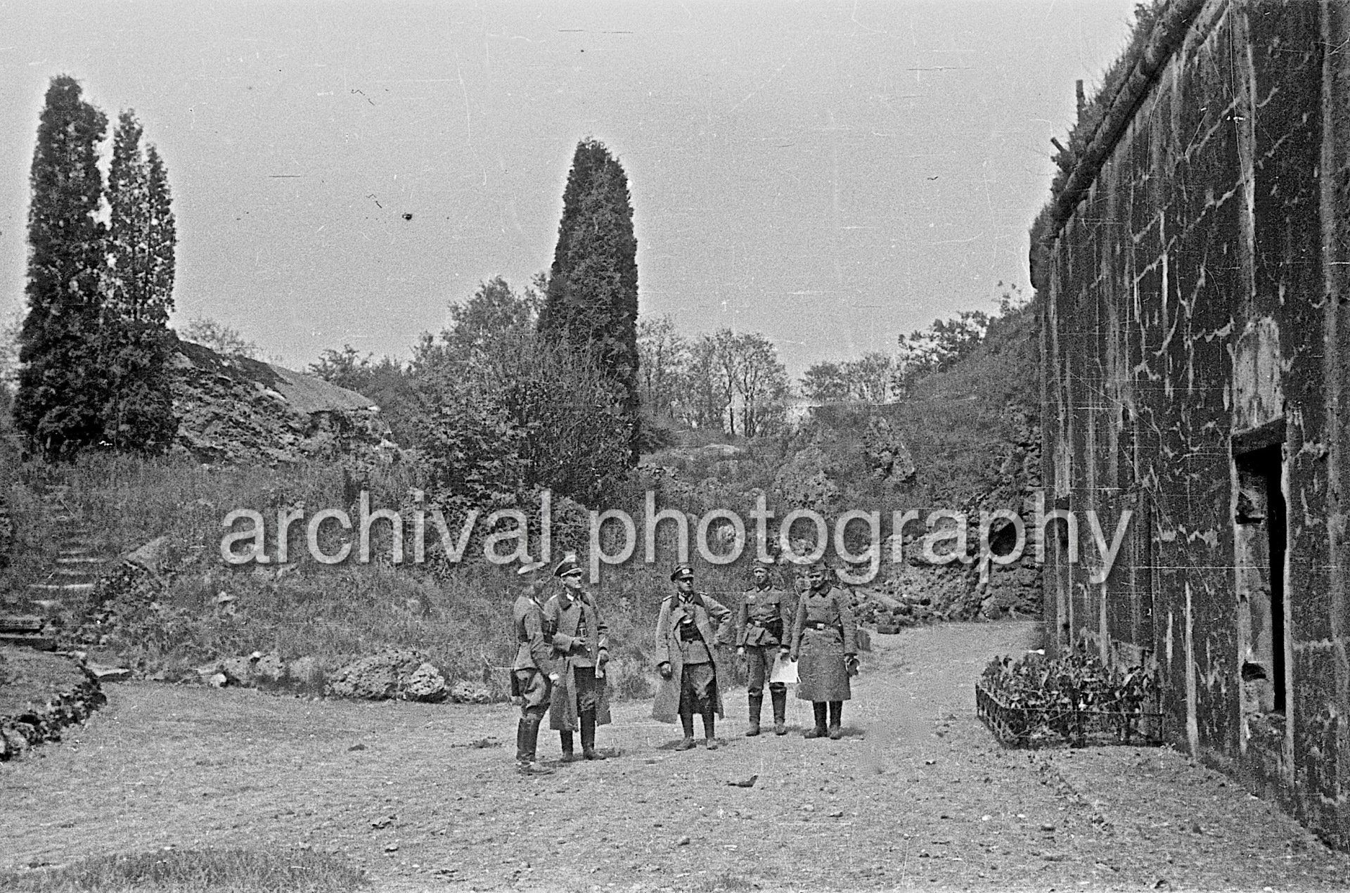 Group of Nazi soldiers standing outside of bunker - Damaged Bunker - Belgian Fort Eben-Emael May 1940