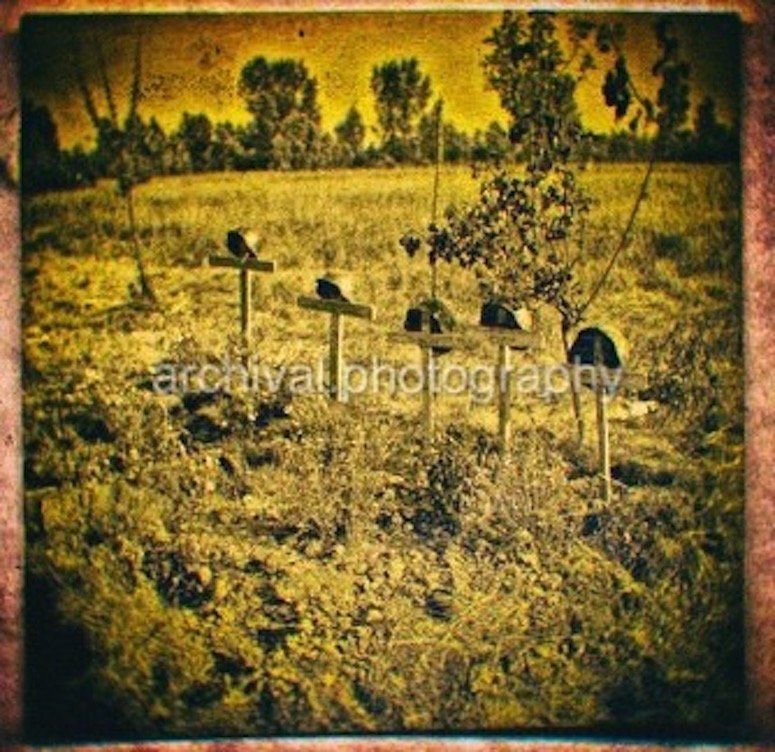 HELMETS AND CROSSES ON BATTLE FIELD