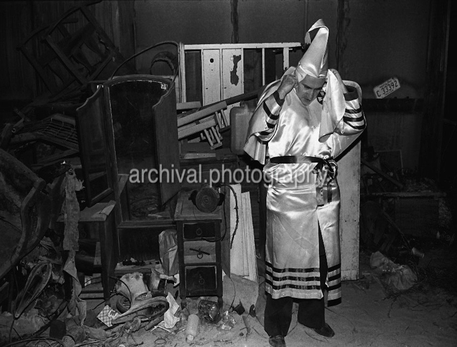 Ku Klux Klan - Klan member putting on HIS hood IN STORAGE SHED