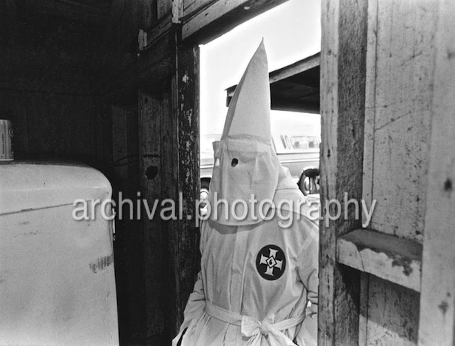 Ku Klux Klan - KKK member entering shed DOORWAY