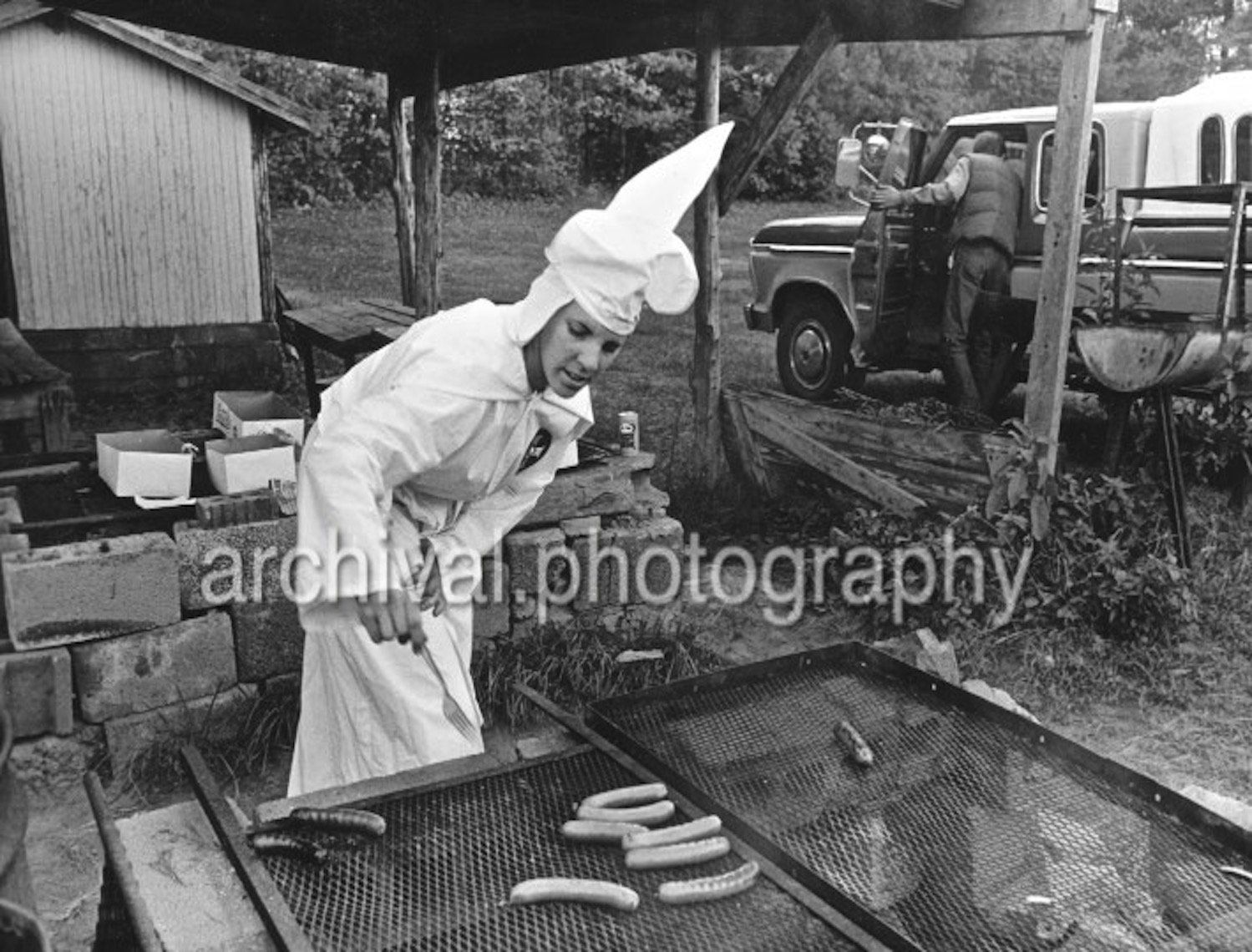 Ku Klux Klan - FEMALE KKK member grilling hot dogs
