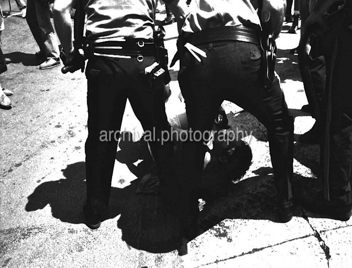 Two police officers beating up a man