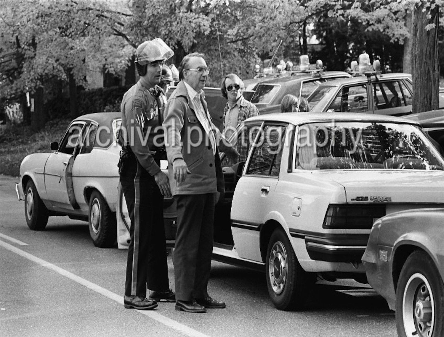 Elderly gentlemen getting patted down by police