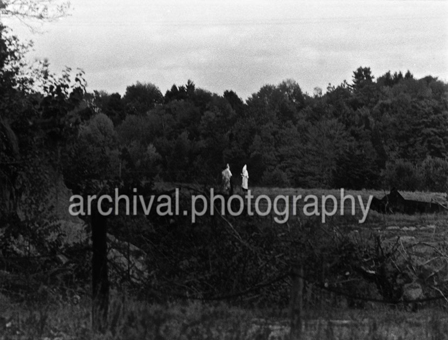 Ku Klux Klan - Two KKK members standing in a field