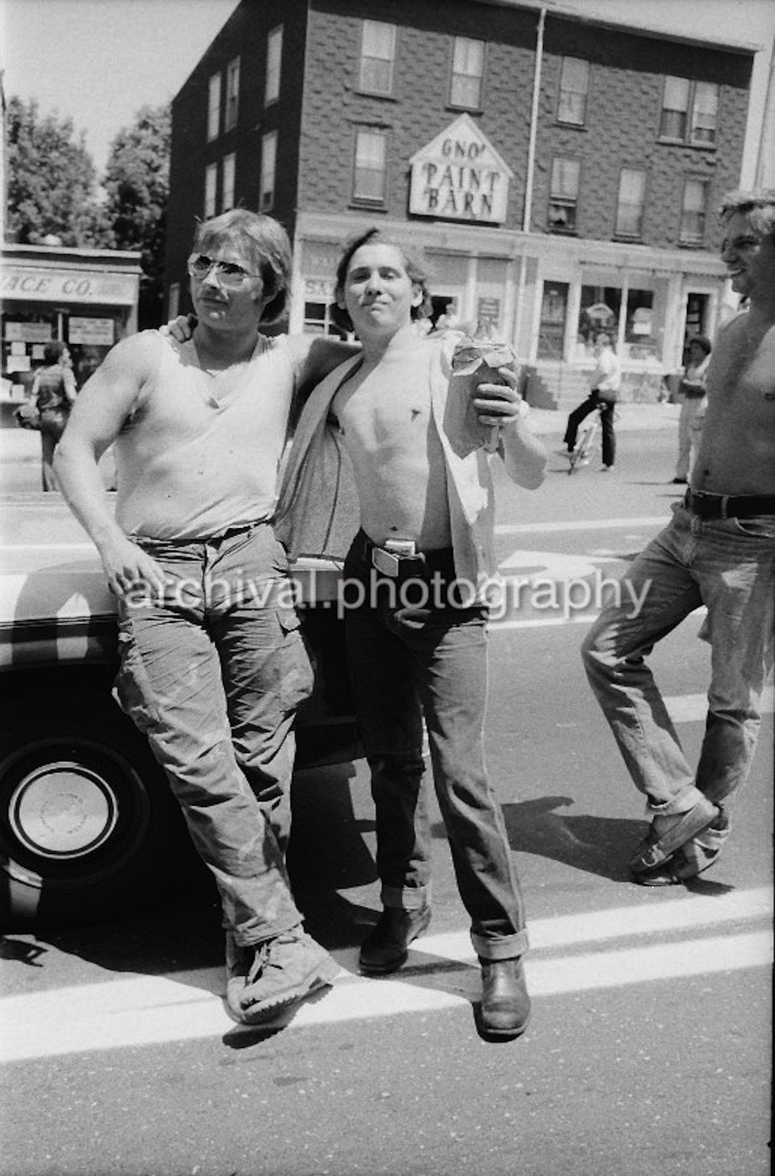 Two men standing on the side of the road