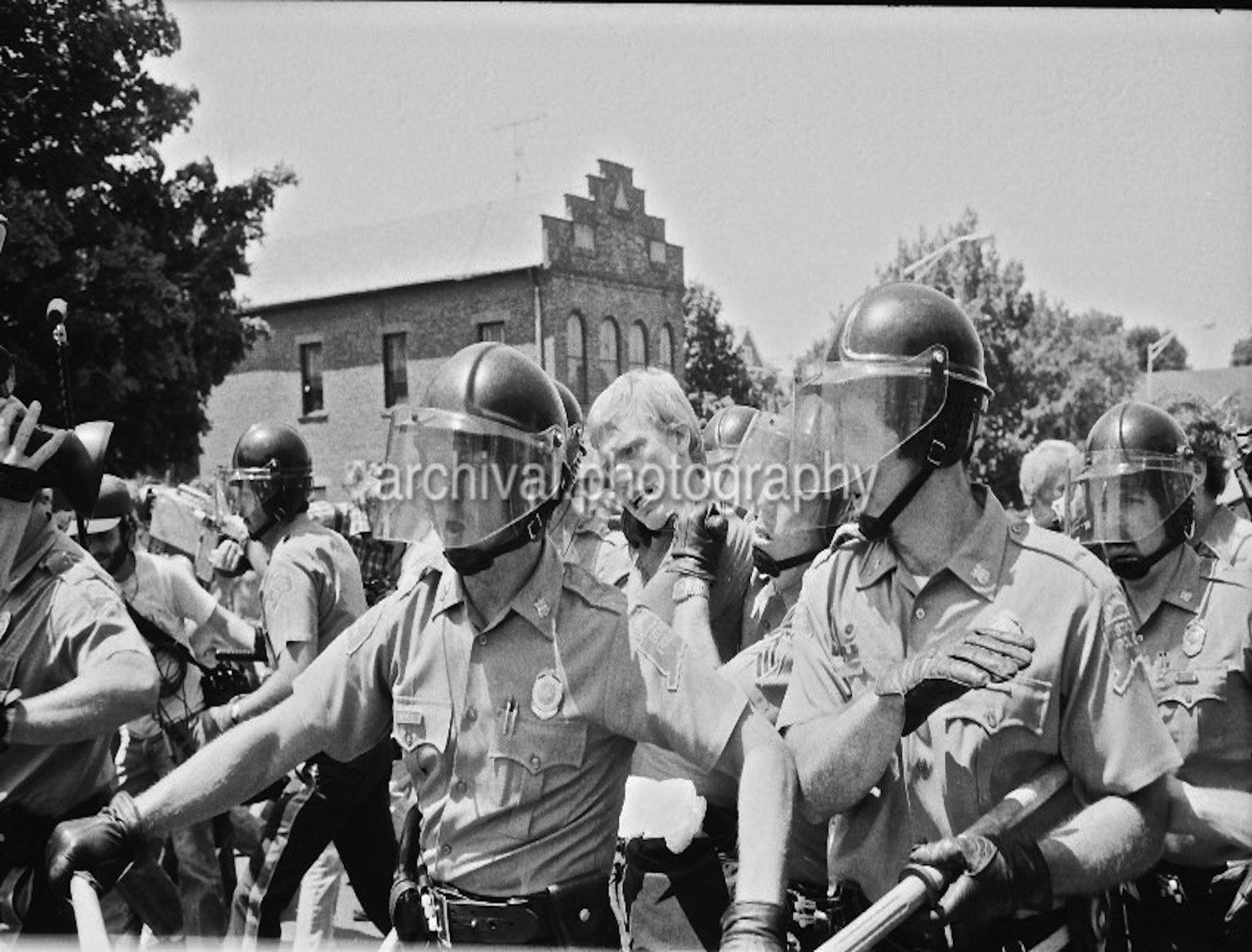 Riot police walking through town together