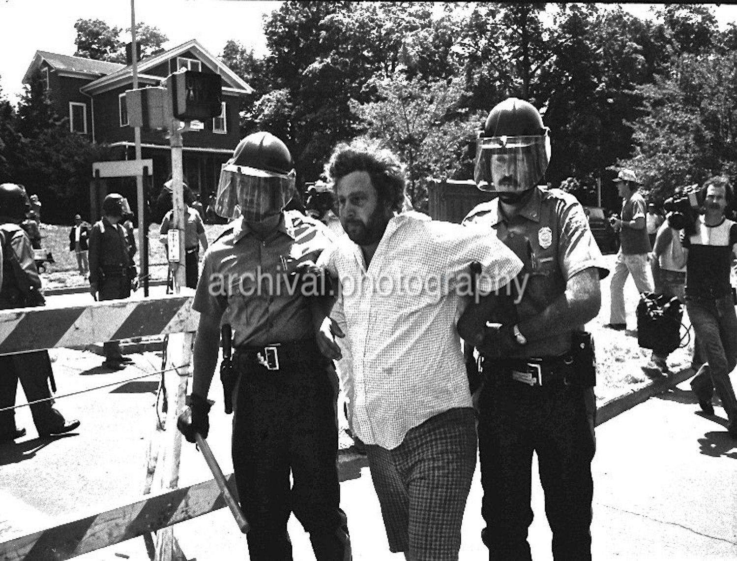Man being arrested by riot police