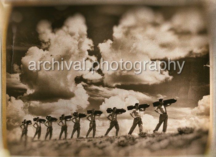 US AIR CORPS Soldiers carrying bombs across field