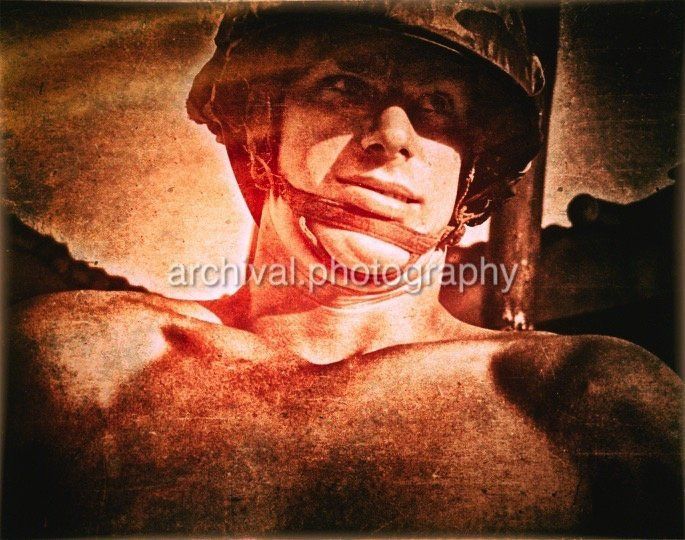 Portrait of BARE CHESTED US MARINE with helmet
