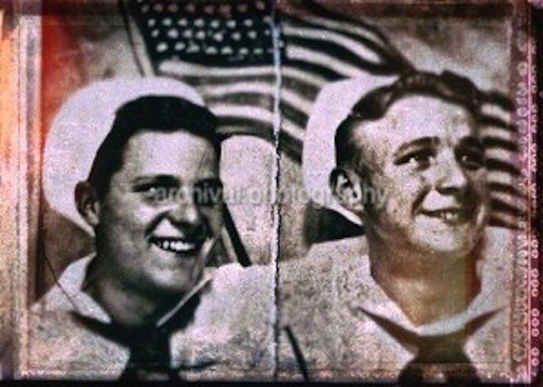 Two US sailors in front of American flag