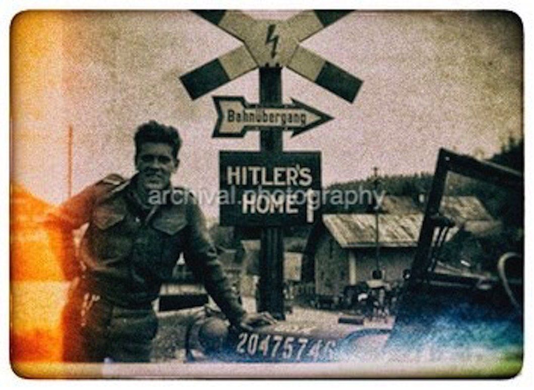 US ARMY Soldier standing in front of HITLER road sign