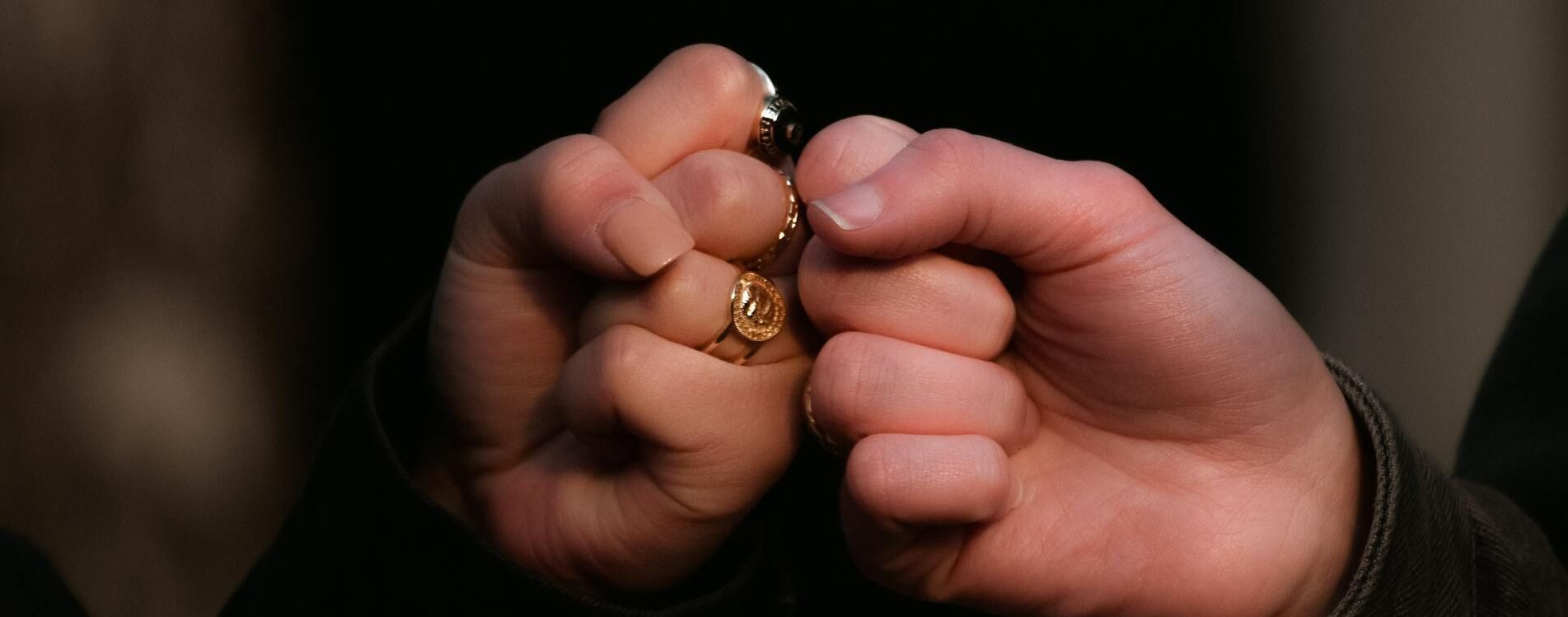 Two people embracing in full support of each other, greenery in the background