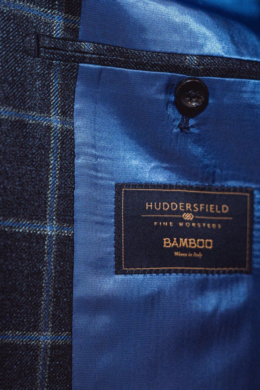 A client wears a dashing blue Vegan sports court, handmade by Adam Davies of Adam James Bespoke